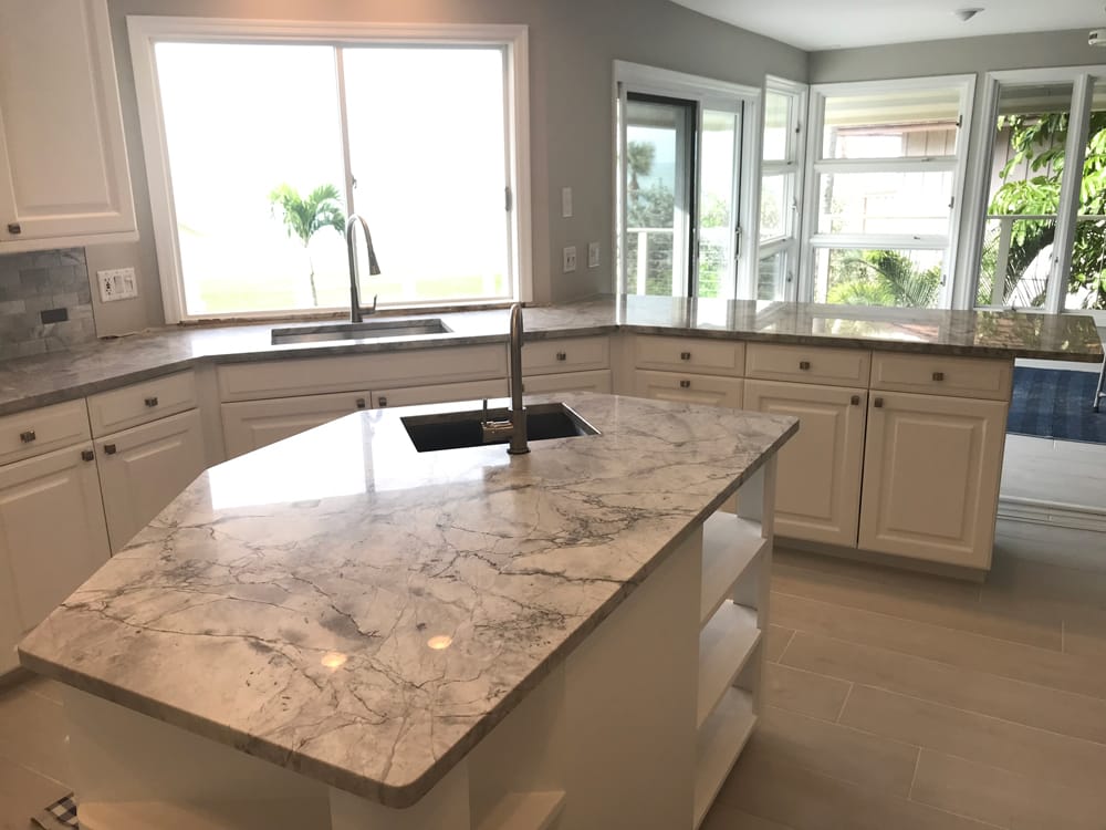 Kitchen with white cabinets with two sinks and grey quartz countertops